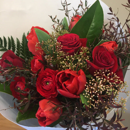 Luscious red bouquet with roses and assorted flowers