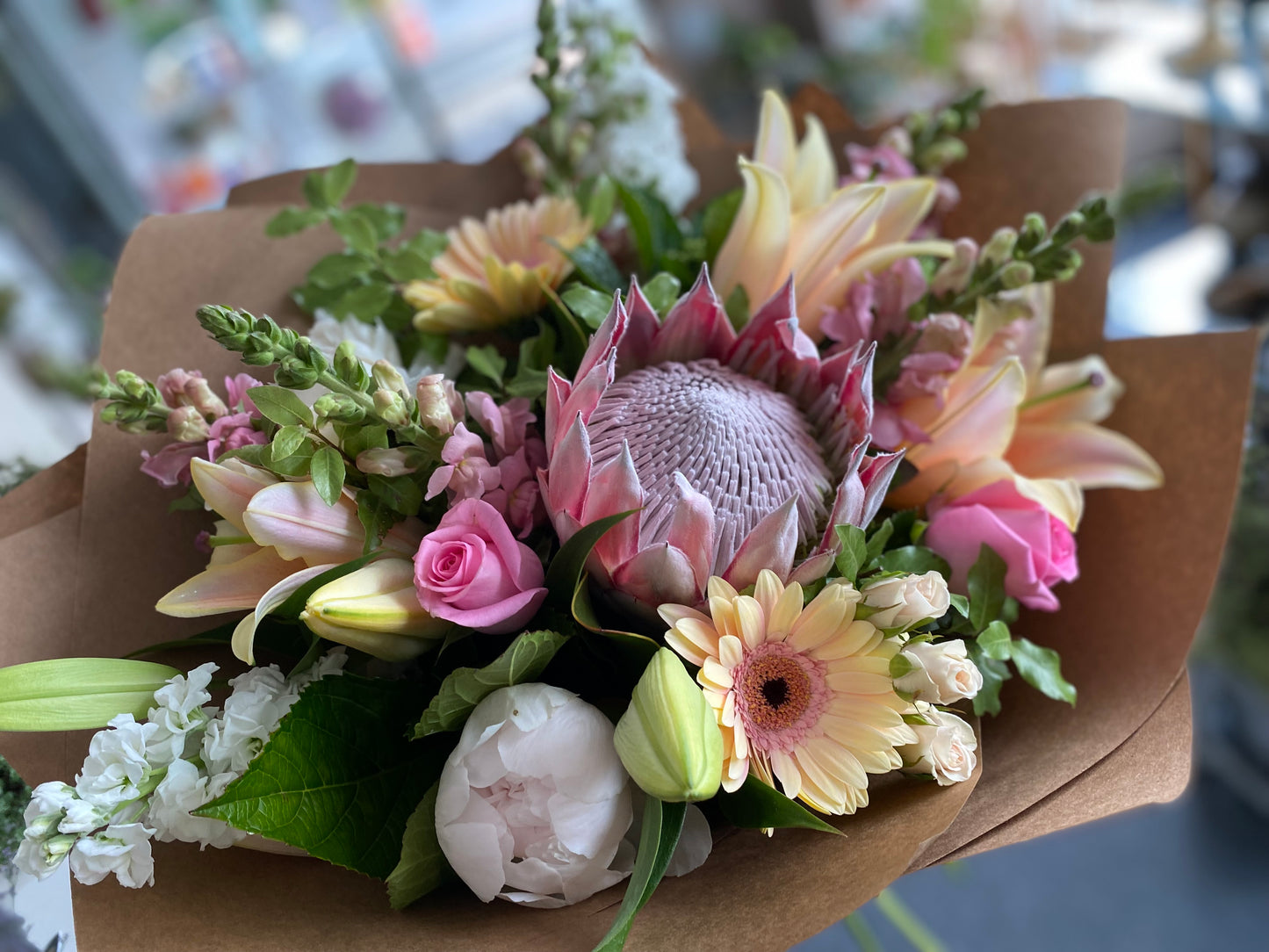 Pink and white mixed bouquet with protea, lilies and assorted flowers