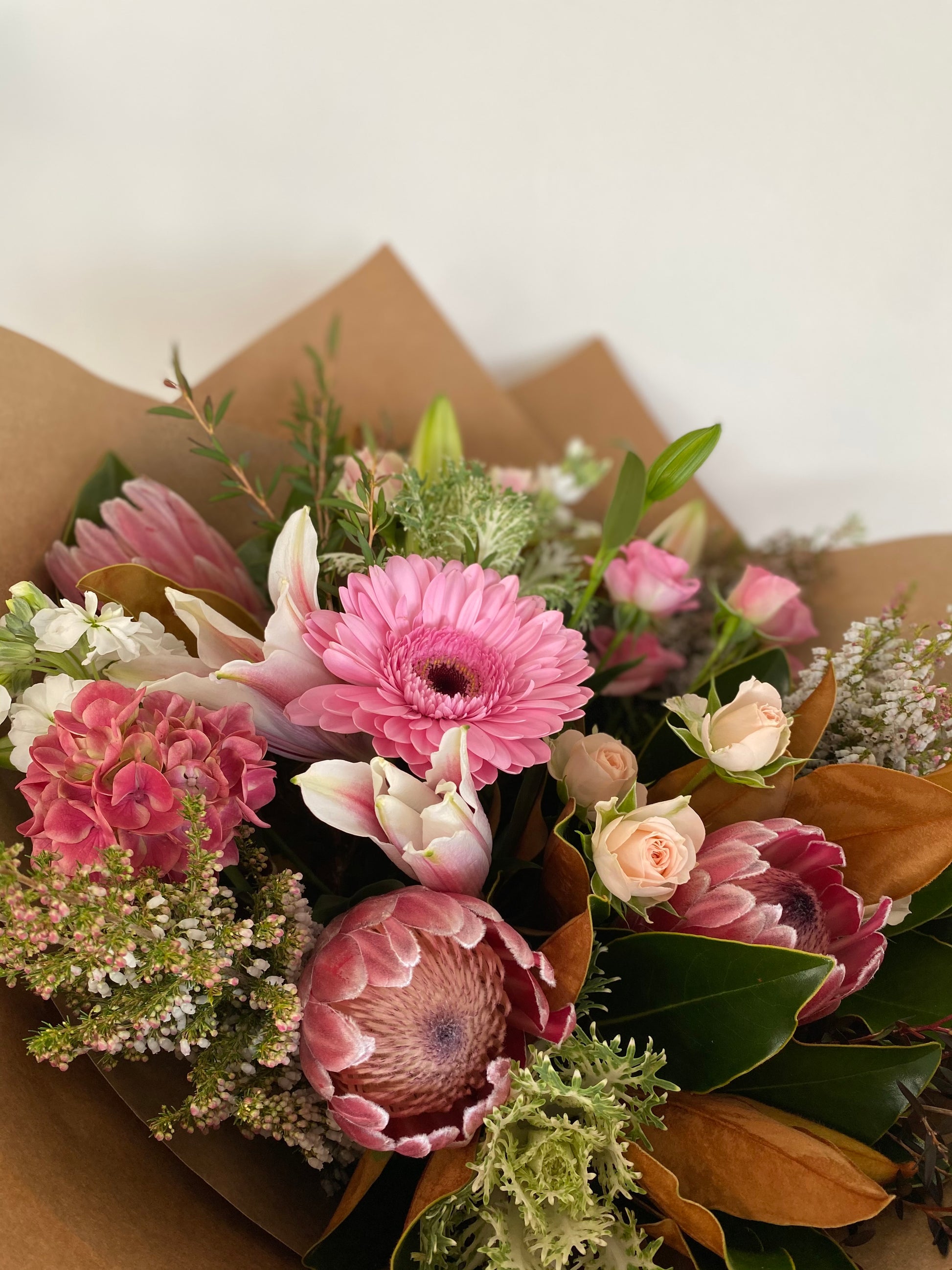 Elegant Pink protea, lilies and mixed foliage perfect for any occasion 